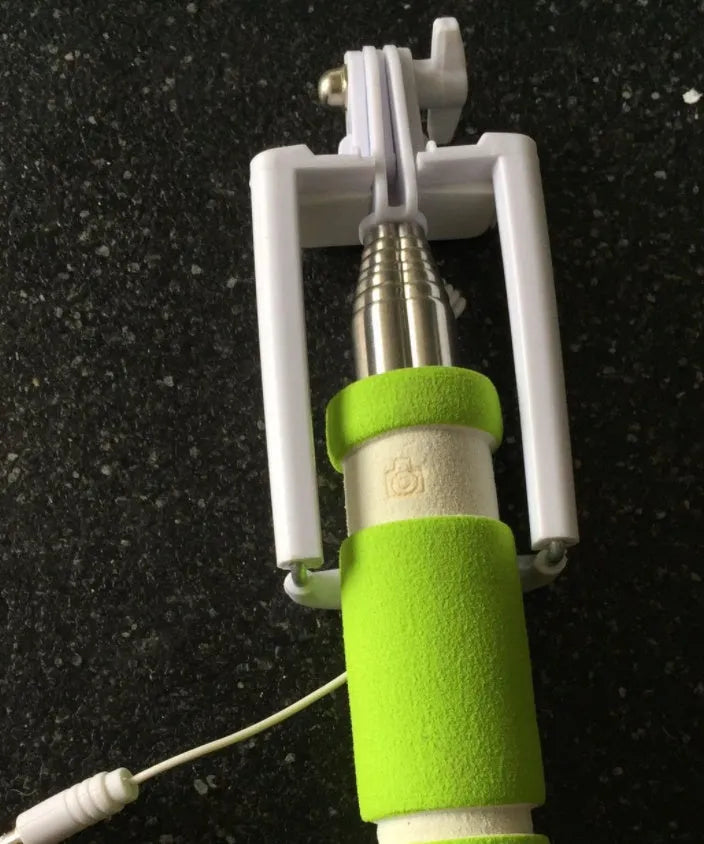 Cell phone folding selfie stick in black plastic, collapsed for storage