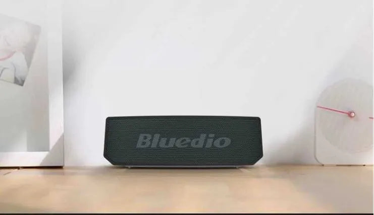 Black rectangular Bluetooth speaker with grille front showing 52mm drivers
