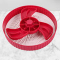 Rotating plastic pet slow feeder bowl with silicone anti-choke mat in windmill pattern.