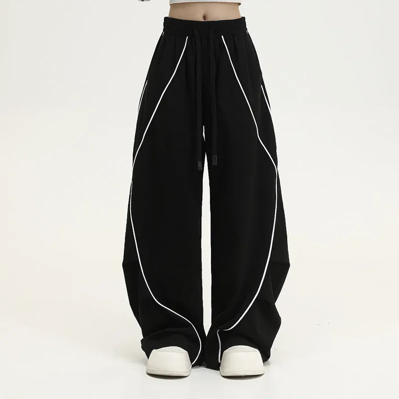 Black pleated wide-leg hip hop sports trousers with a striped pattern.