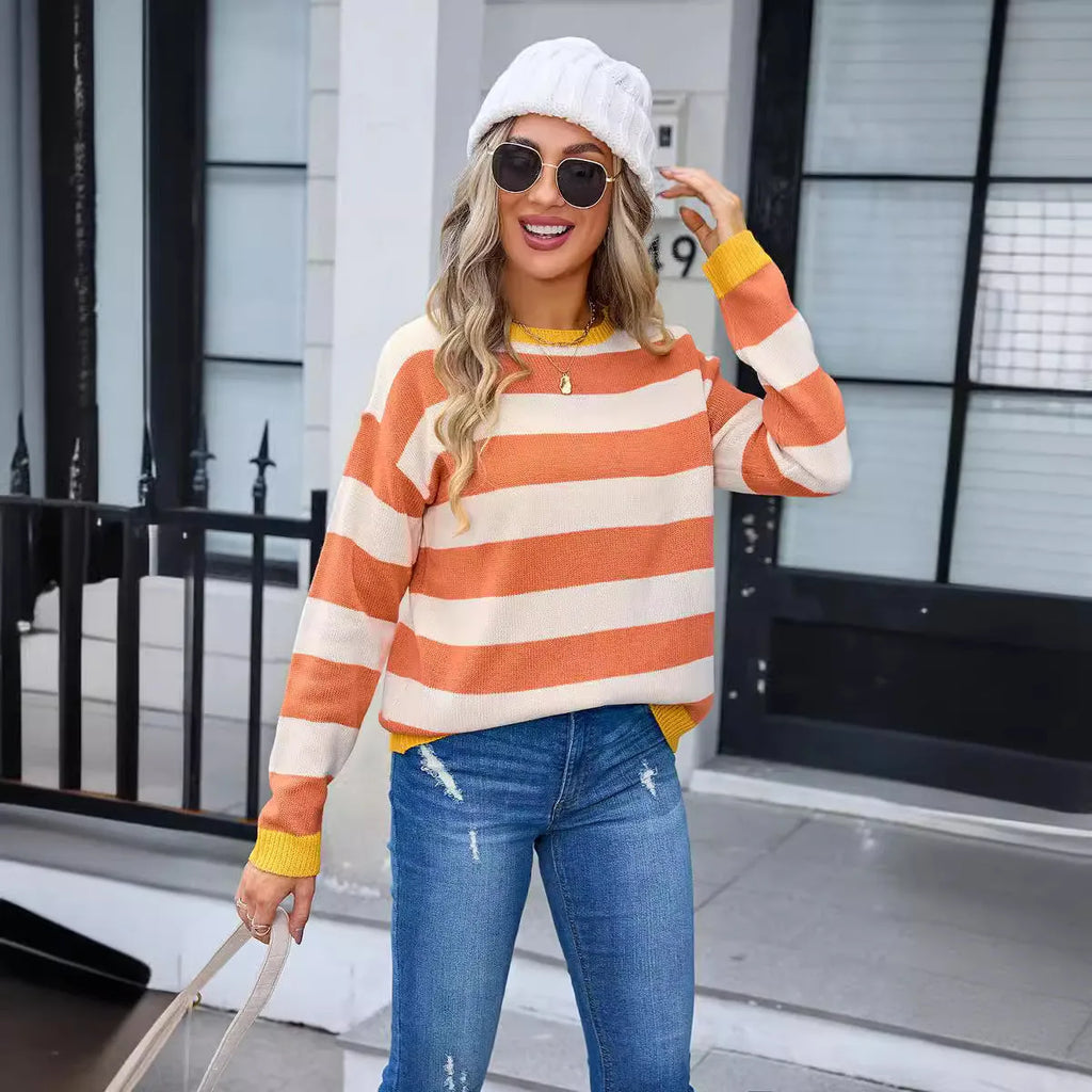Loose fit women's acrylic sweater with round neck and long sleeves on a hanger