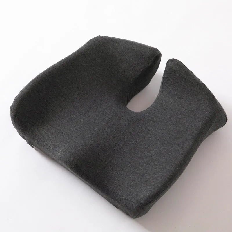 Memory foam office chair cushion in a solid colour, shown on a desk chair for scale.