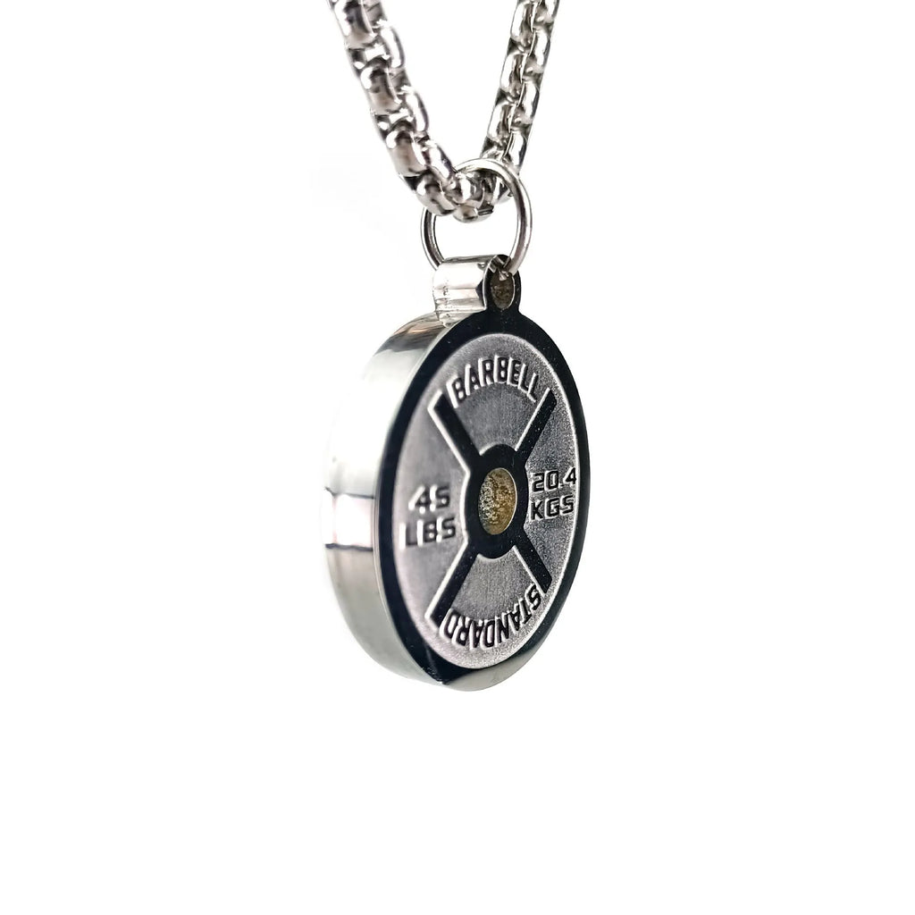 Polished stainless steel barbell disc pendant on a 60cm chain, showing geometric fitness jewellery design.