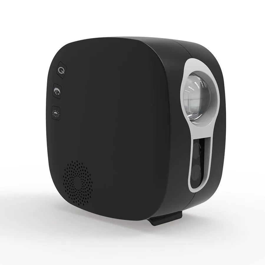 Laser starry sky projection lamp with colourful nebula moon effect and Bluetooth music playing, black unit on a desk