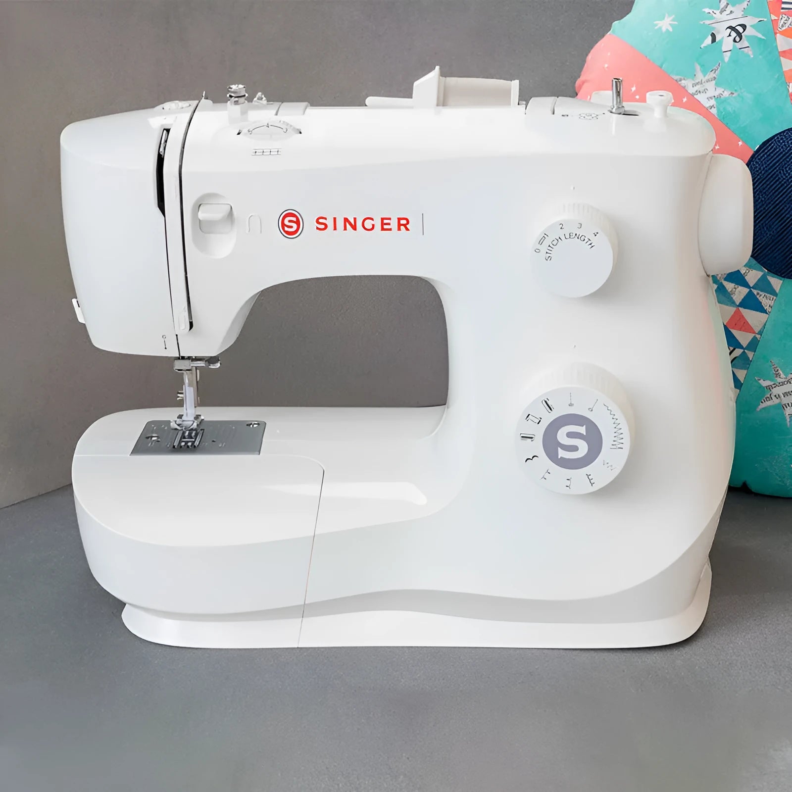 Portable household sewing machine M2405 on a table, compact design, 47x39x26cm, for thick fabric sewing