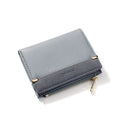 Open view of a short black PU leather ladies wallet showing multiple card slots, a zipper compartment, and a change pocket.