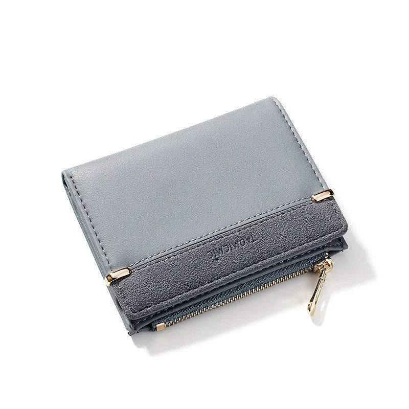 Open view of a short black PU leather ladies wallet showing multiple card slots, a zipper compartment, and a change pocket.