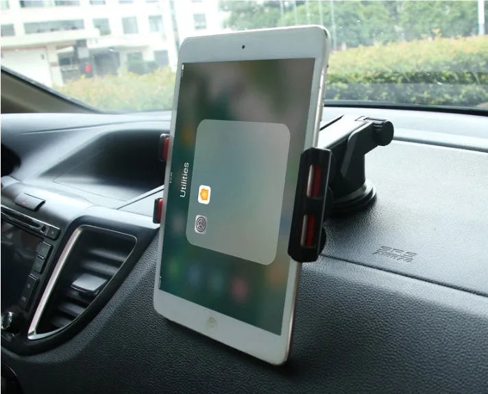 Black tablet PC universal stand car bracket mounted on dashboard centre console holding a tablet