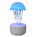 White resin jellyfish humidifier diffuser with 7-colour night light and touch controls on a desk