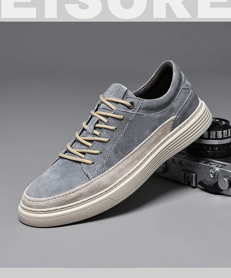 Men's grey low-top casual skate shoes with a pigskin leather upper and rubber sole.