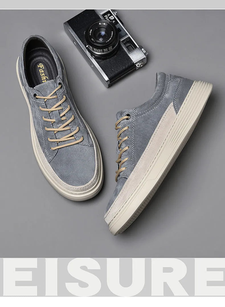 Men's grey low-top casual skate shoes with a pigskin leather upper and rubber sole.