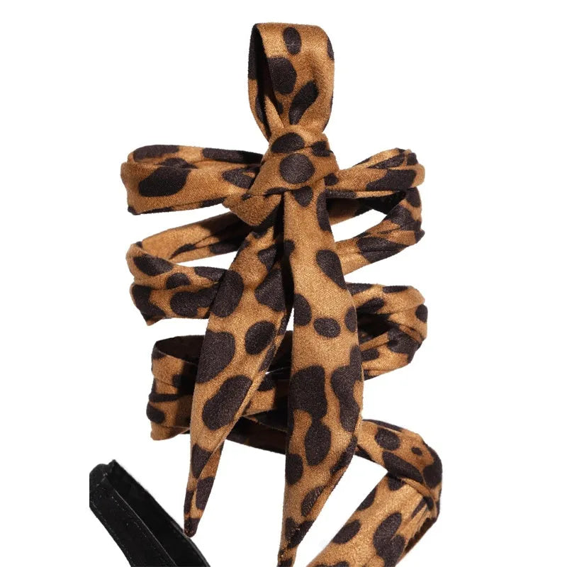 Light brown leopard print women's high heels with Roman cross straps and a high thin heel