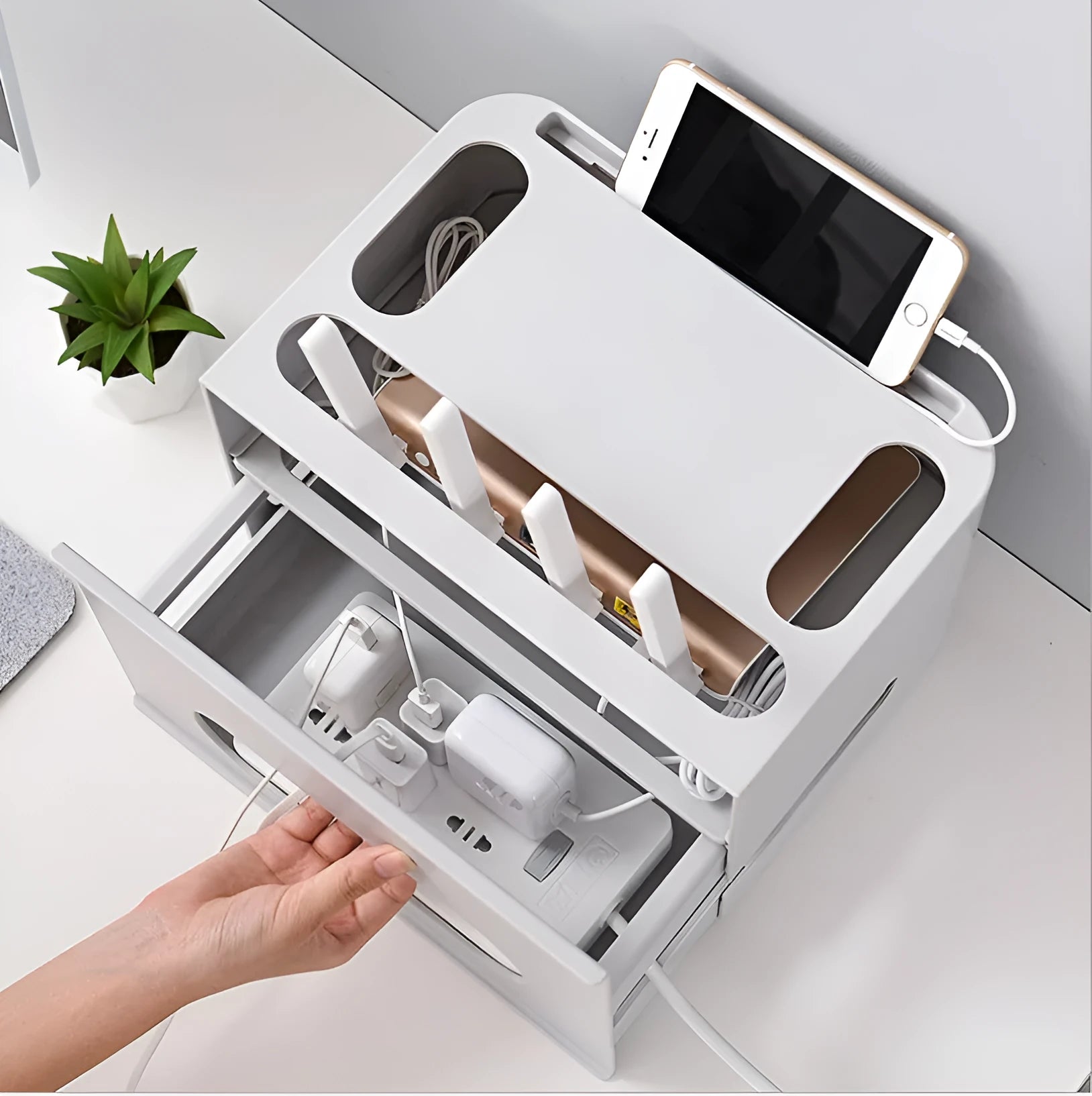 Plastic wireless router storage box in grey, with cable openings, for organising home networking equipment