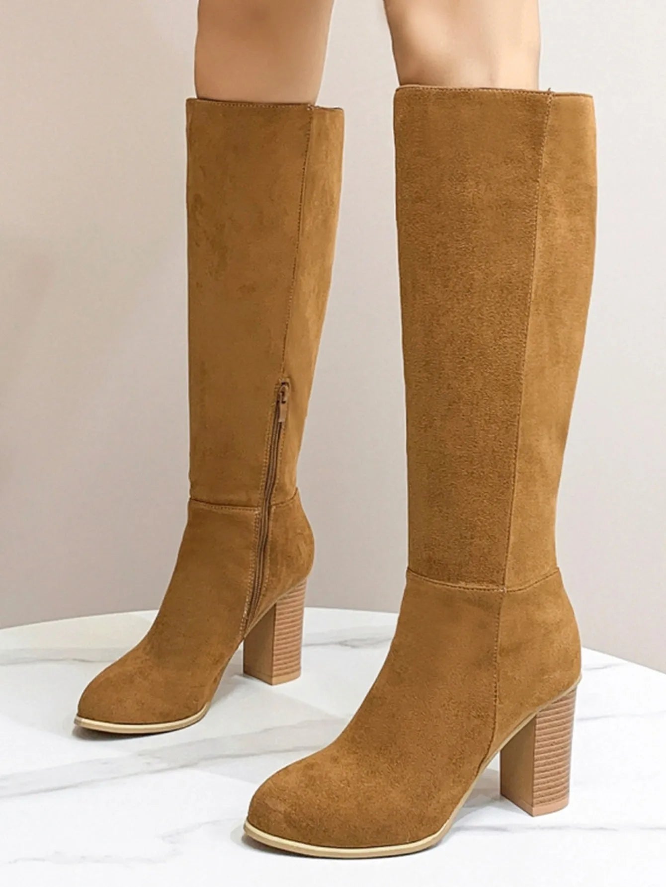 Women's black square toe high heel fashion boot made from artificial PU material.