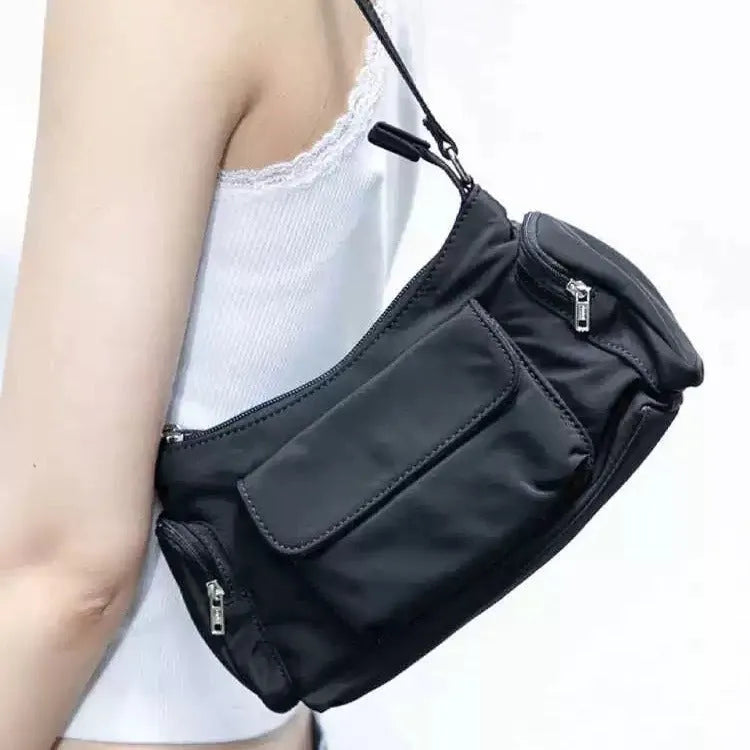 Simple black lightweight women's PU shoulder bag with two front pockets and side line detail.