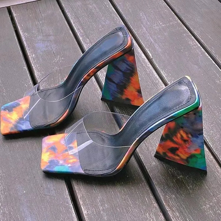 Women's black square toe slippers with a thick triangle heel on a rubber sole.