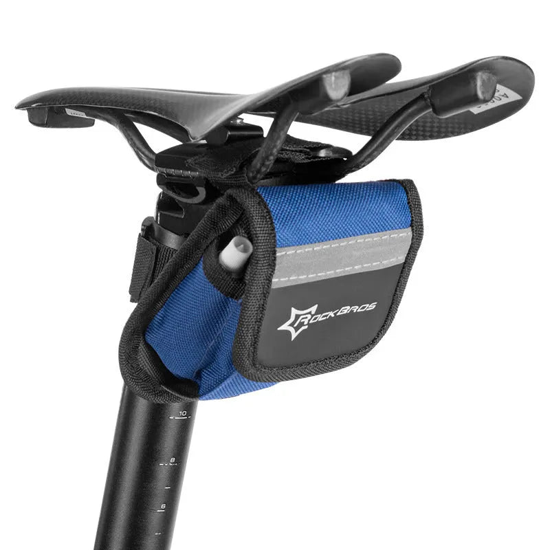 Portable bicycle tire repair kit in storage pouch mounted on upper tube of bike frame, with maintenance tools visible