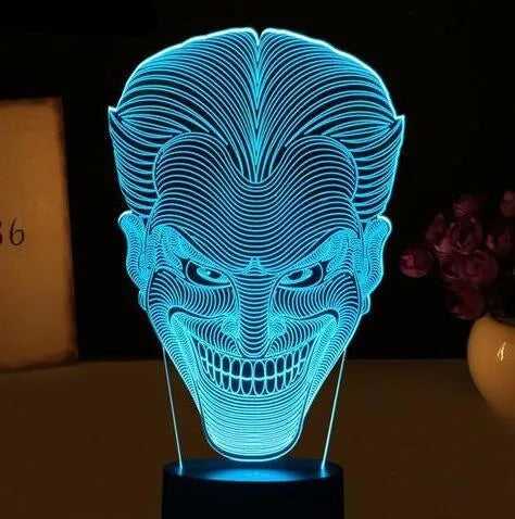 USB-powered 3D acrylic LED lamp showing colour gradient effect, with remote control and base on a desk.