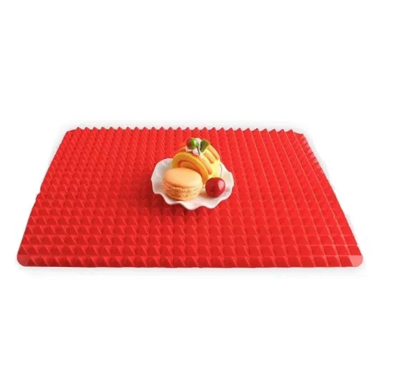 Red non-stick silicone pyramid cooking mat on a baking tray, showing grid pattern and 39.5 cm size