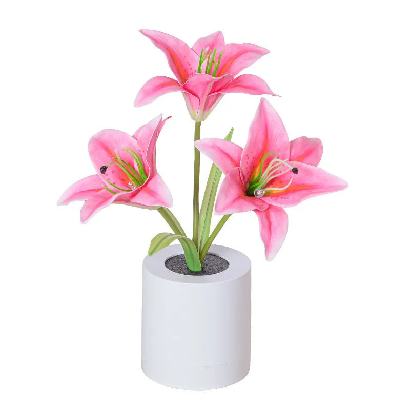 Rechargeable LED lily flower pot lamp in lily-pink colour, flower shape, on tabletop