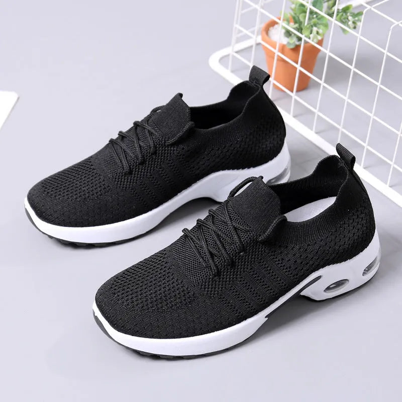 Women's black mesh lace-up sneakers with a soft sole on a white background.