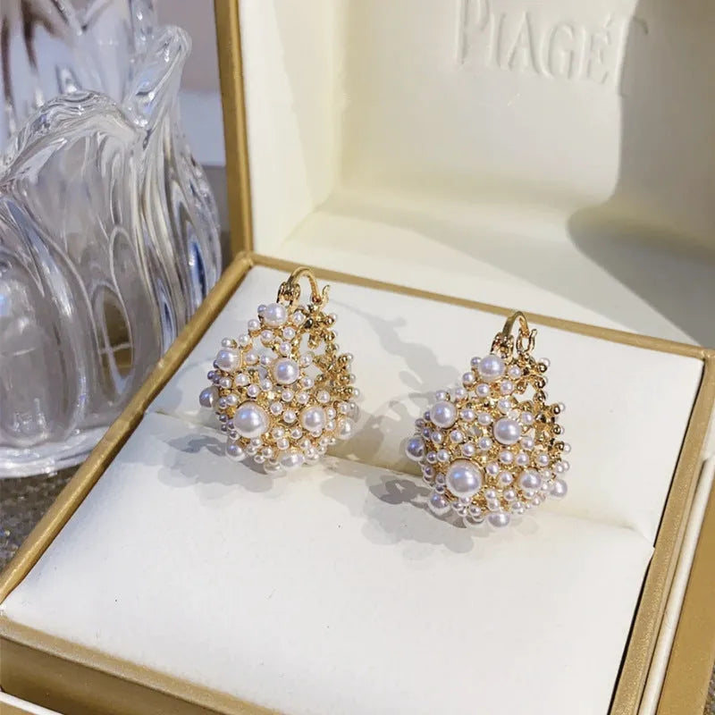 Gold copper drop earrings with small rice-shaped pearl inlay in a flower basket shape for women