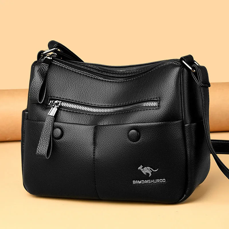 Soft PU leather crossbody bag in horizontal square shape with stitching detail, showing multiple colour options black dark blue wine red yellow.