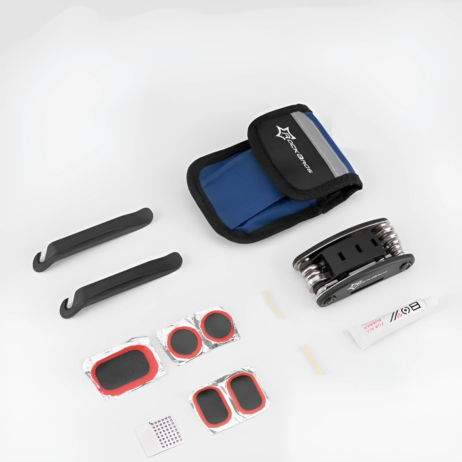 Portable bicycle tire repair kit in storage pouch mounted on upper tube of bike frame, with maintenance tools visible