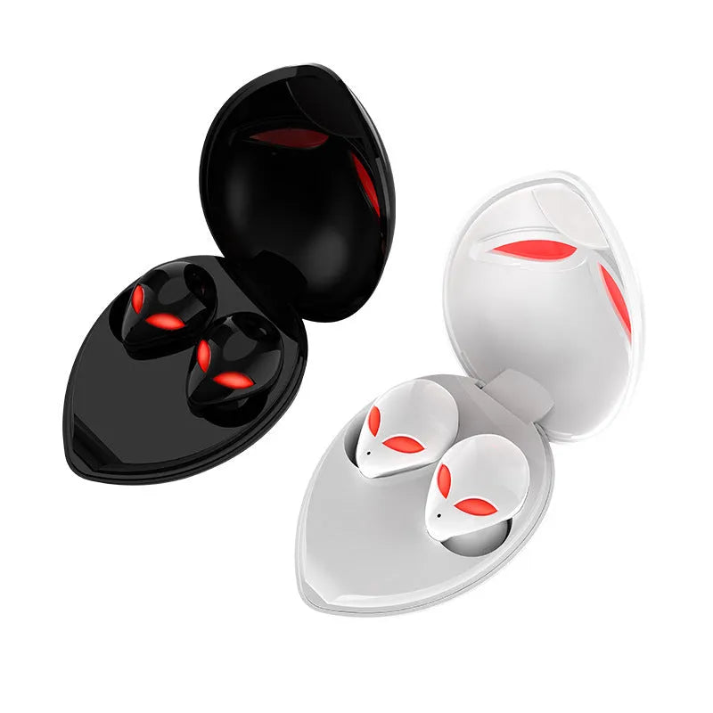 Creative Outer T8 Starman black and white alien design wireless earbuds with LED lights next to charging case.