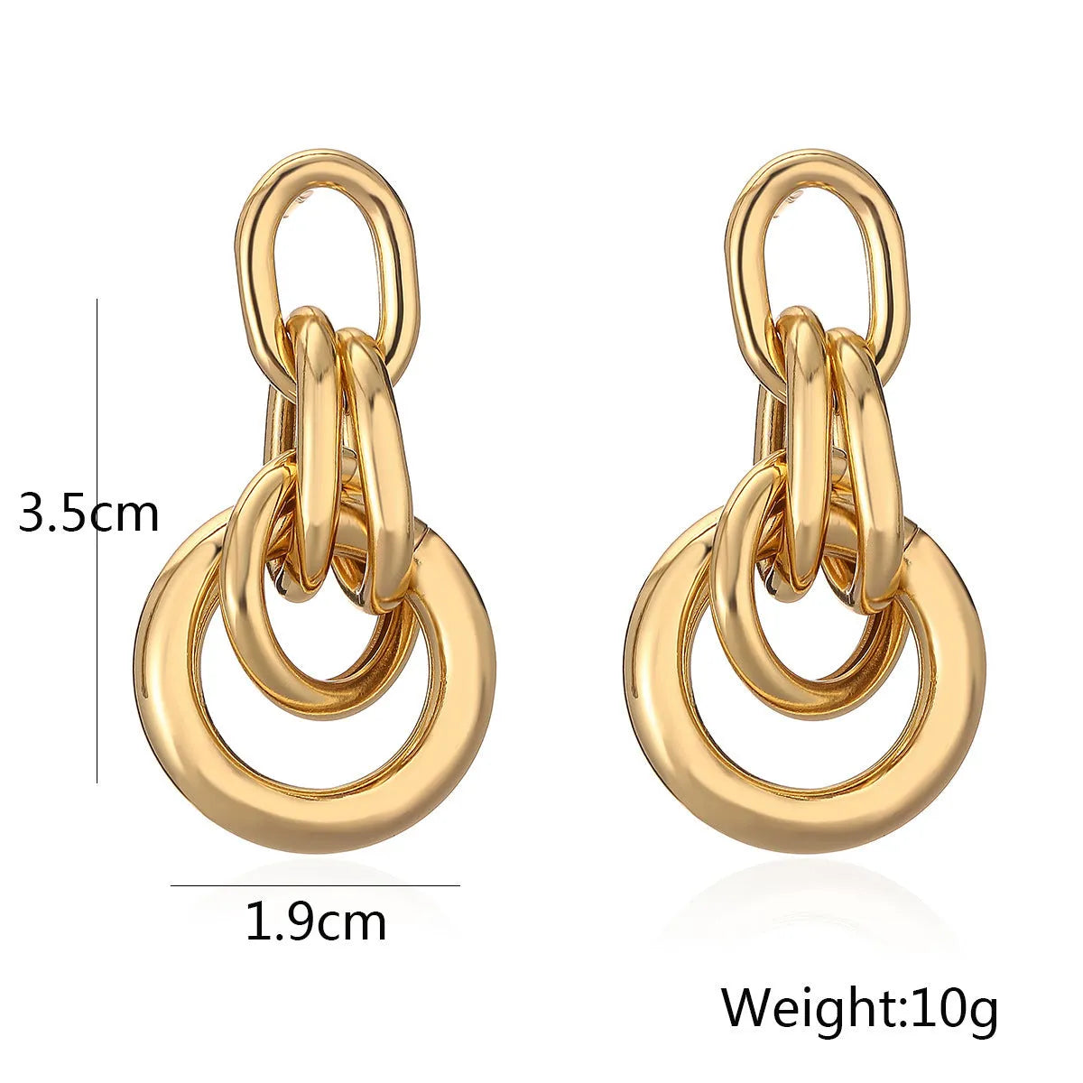 A pair of gold-coloured geometric copper earrings with irregular shapes on a white background.