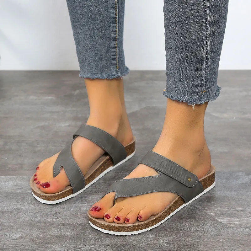 Flat toe ring flip-flops with thick foam sole in blue, shown from the side.