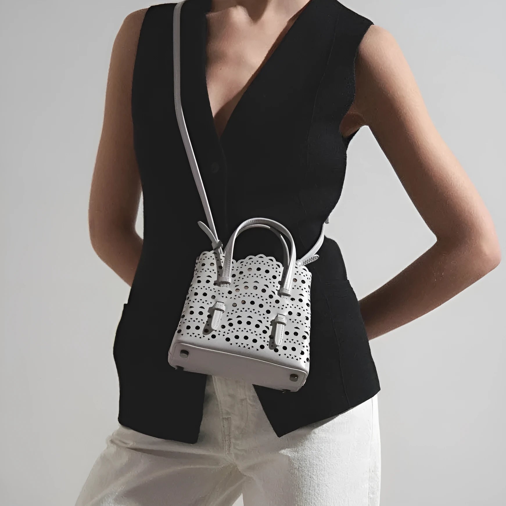 Hollow carved PU leather tote bag in apricot colour with three shoulder straps, horizontal square shape