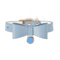 Leather cat collar in brown with matching ring and rope on a neutral background