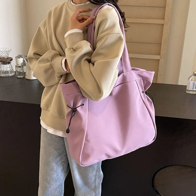 Soft folding Oxford cloth tote bag in a street style, shown in multiple colour options.
