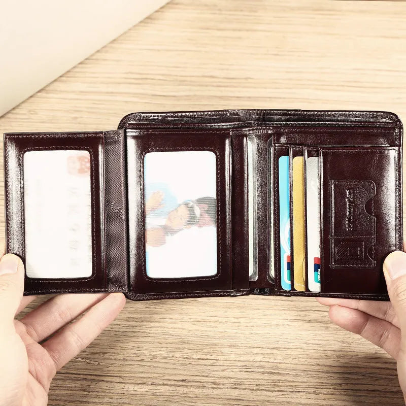 Men's black leather wallet open to show internal compartments for banknotes, cards, coins, and a concealed dark space.