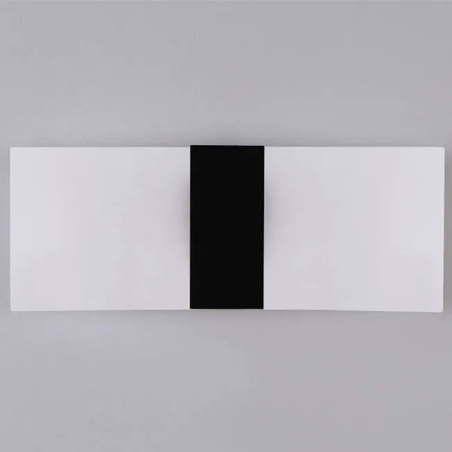 Modern LED bedside wall lamp with acrylic shade, 27x10cm, in black finish, mounted on a wall