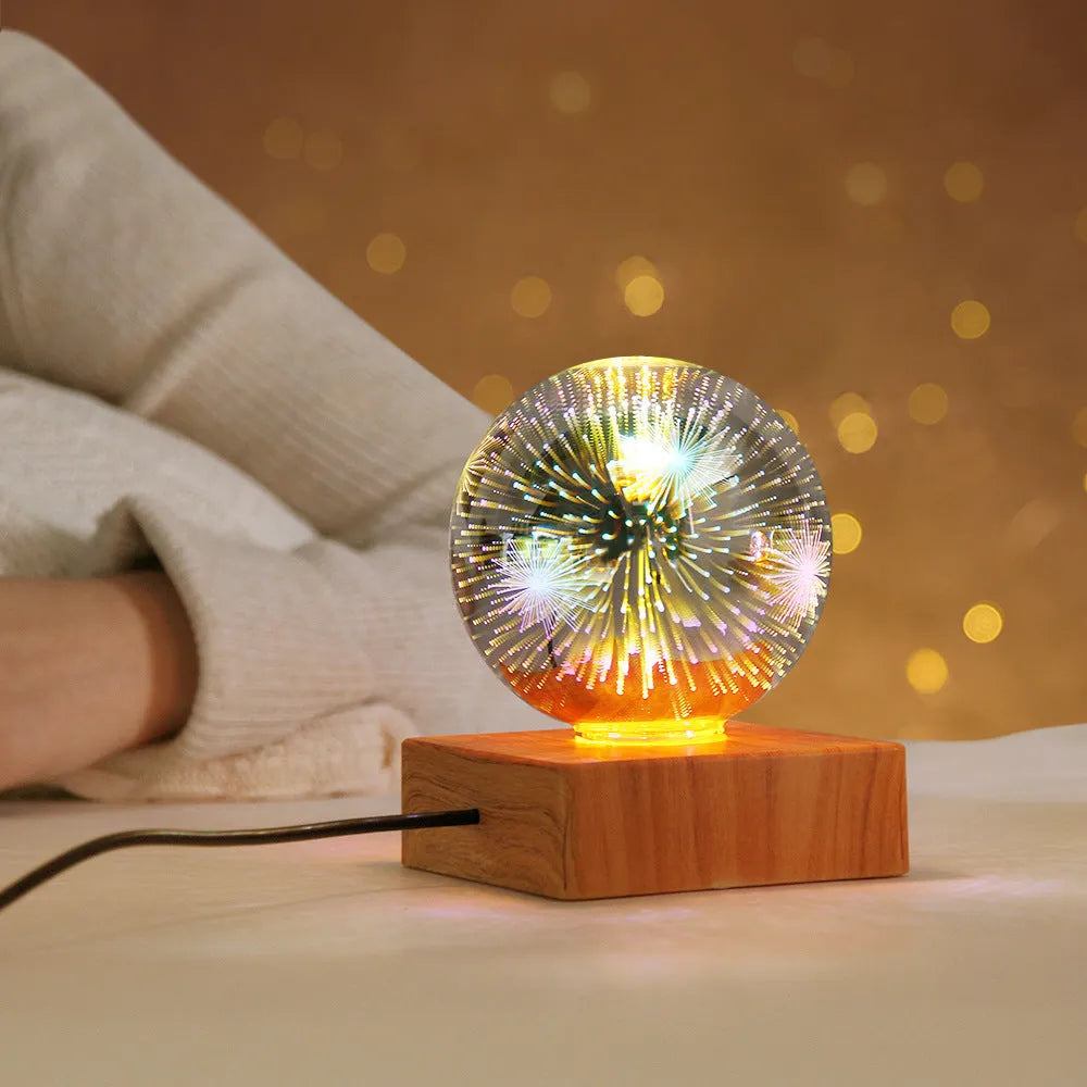 USB 3D firework crystal ball night light with warm LED, touch control, and starry sky effect on a wooden desk