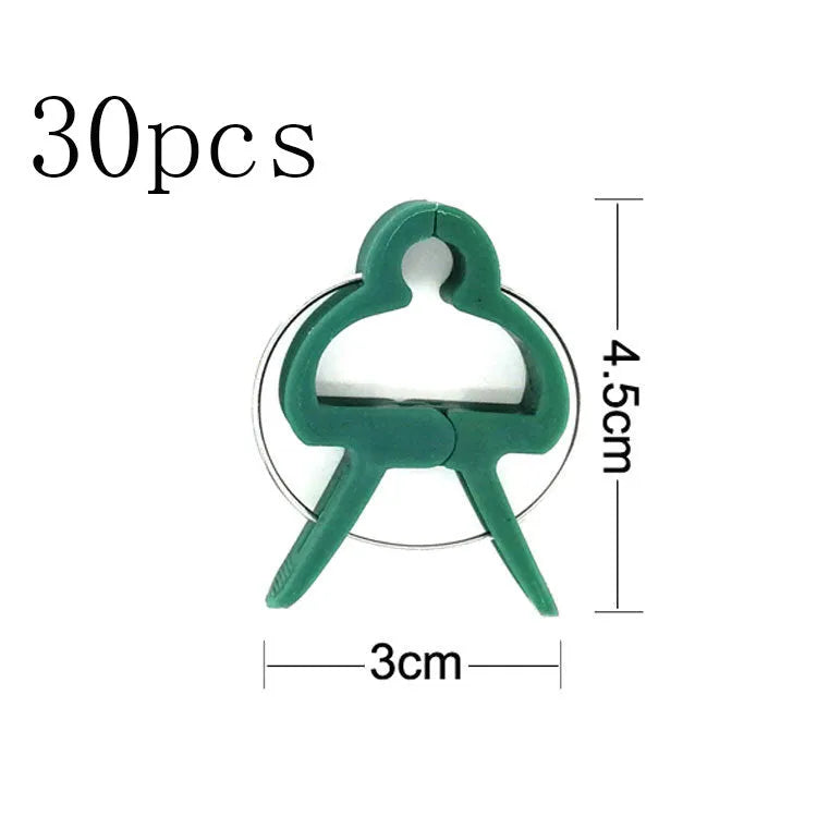 Green plastic and zinc plant fixing clips, large and small sizes, for climbing vegetable support.