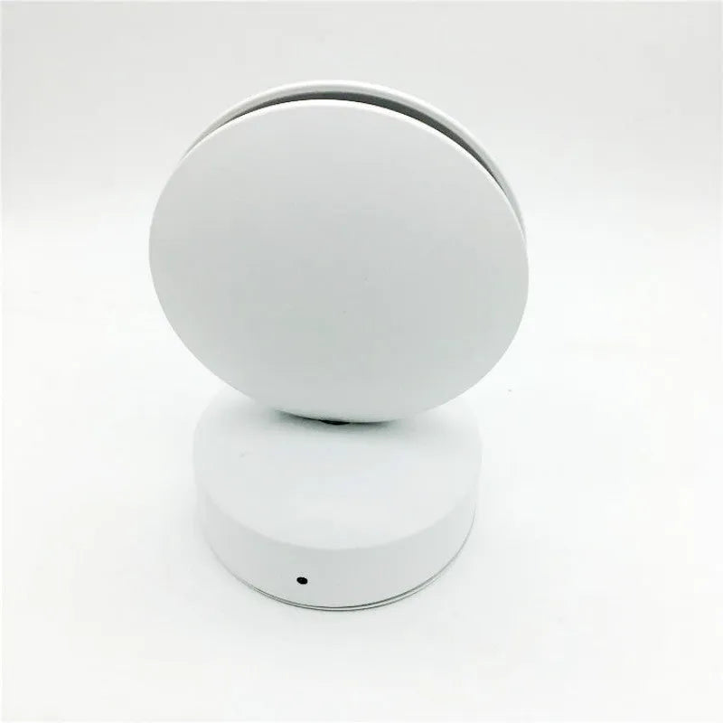 Modern aluminium LED spotlight bar wall lamp emitting coloured light, mounted on a wall.