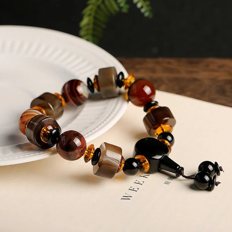 Natural twining line old agate bracelet with sardonyx agate abacus beads and white and red agate spacer beads on neutral background
