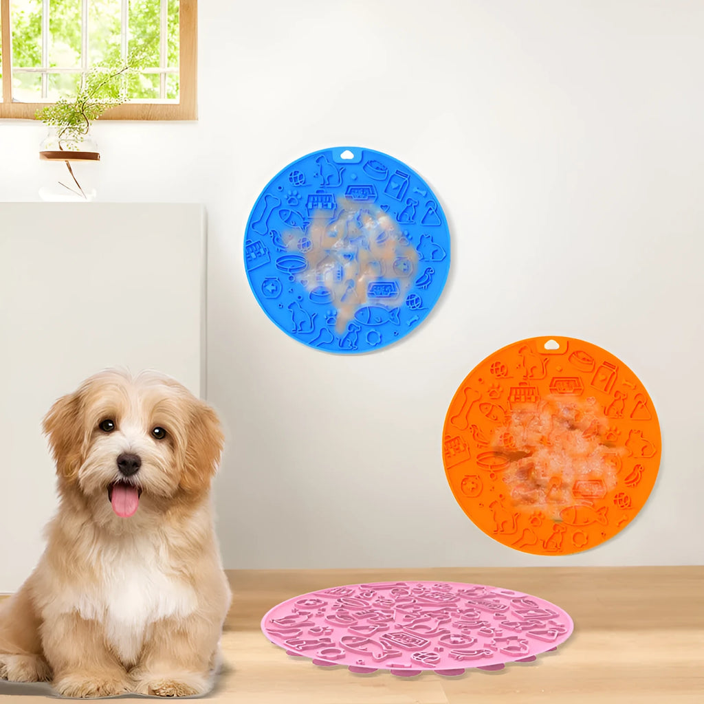 Round silicone pet licking mat with suction cup base in blue, on a kitchen tile floor.