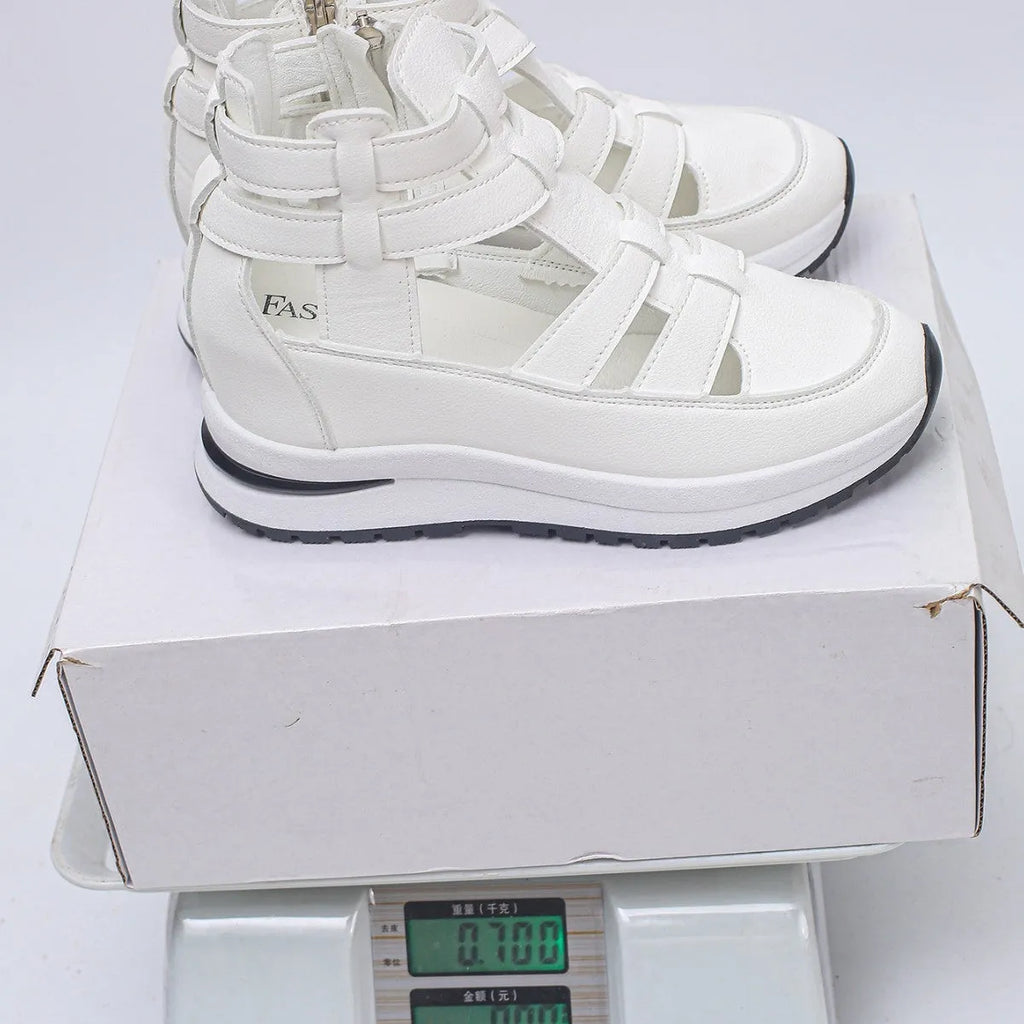 Women's black close-toed platform sandals with hollow-out design and Velcro strap.