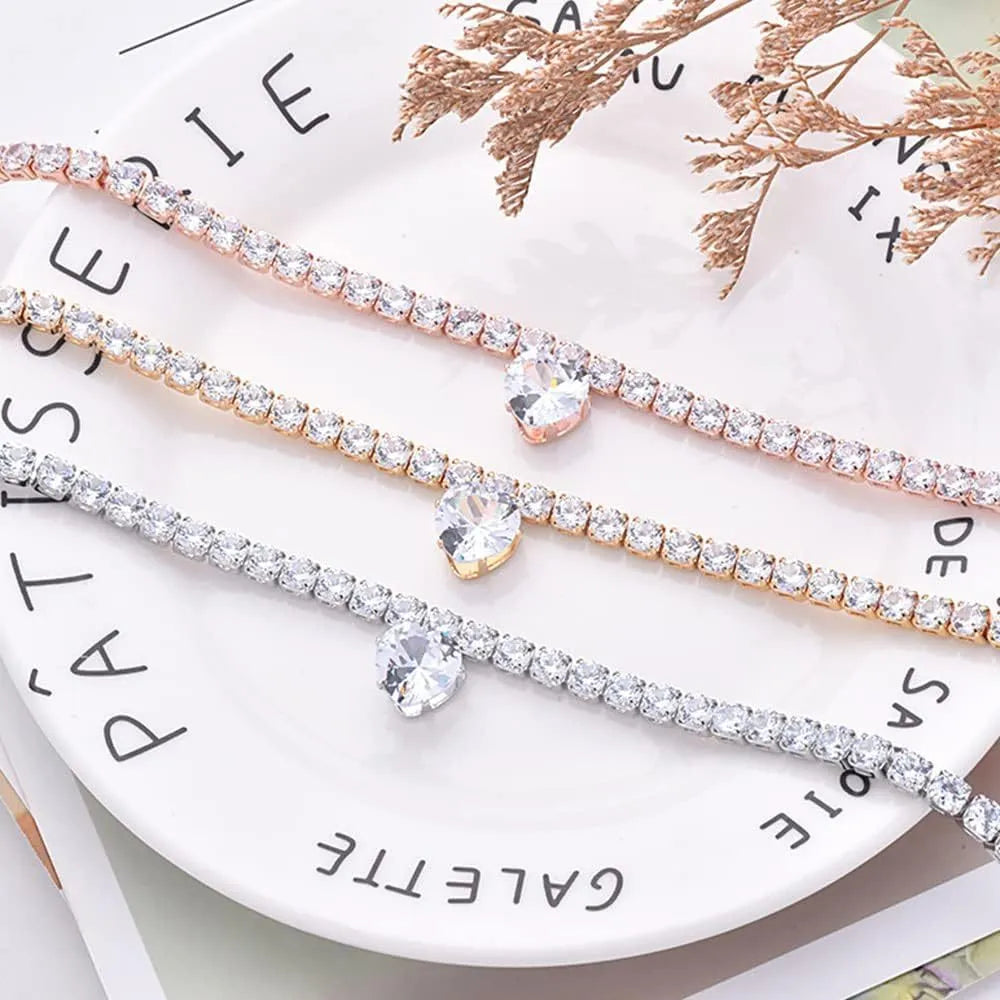 Gold rhinestone heart-shaped decorative collar for a dog or cat, shown with a bling design and an extension chain.