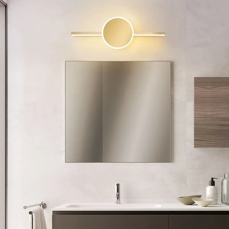 Modern bathroom mirror cabinet with LED vanity lights and a gold-toned frame.