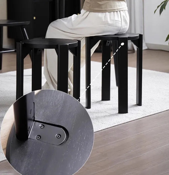 Large stackable iron dining stool in a modern style, shown in smoked black finish.