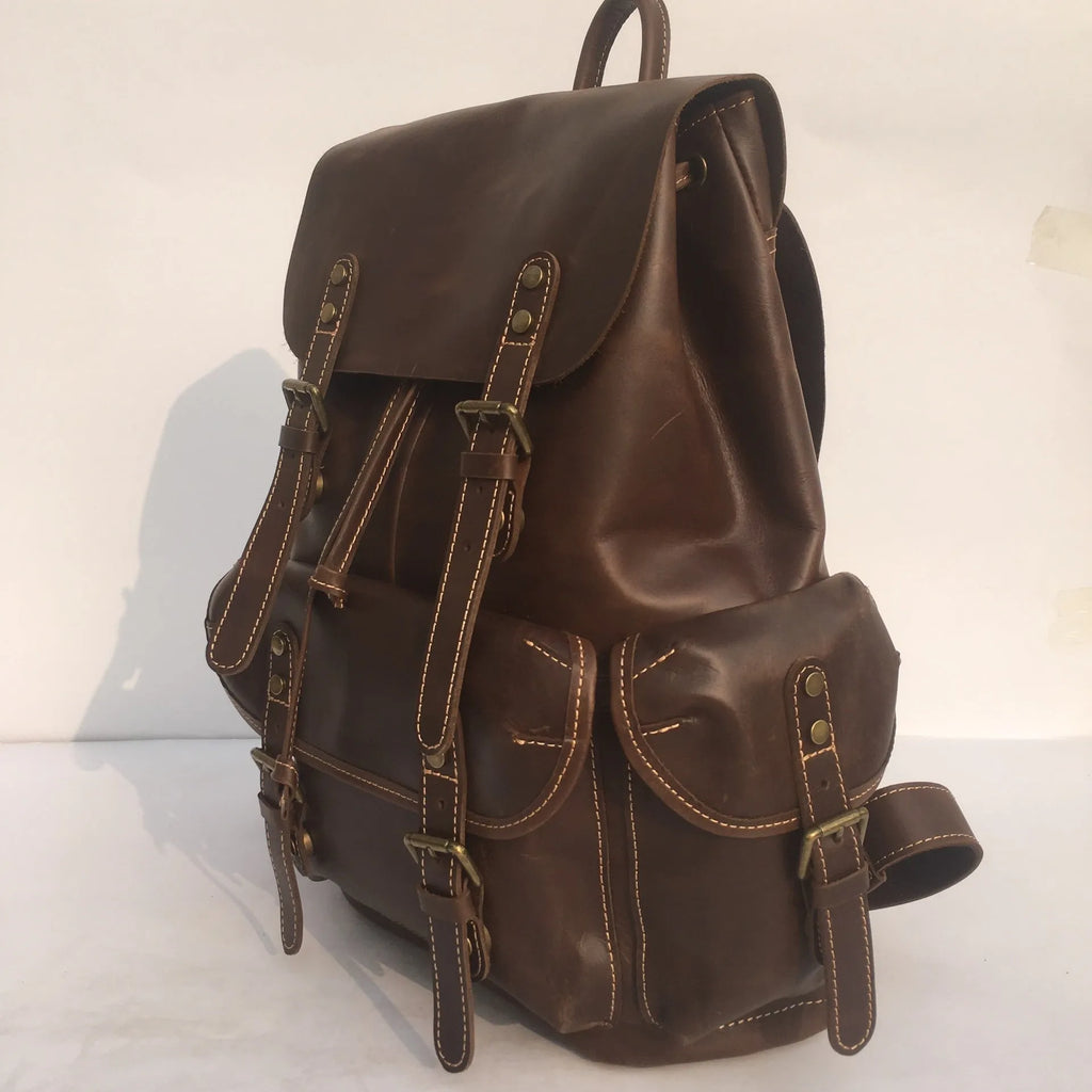 Men's genuine top layer cowhide leather backpack in coffee brown with air pillow belt, front view