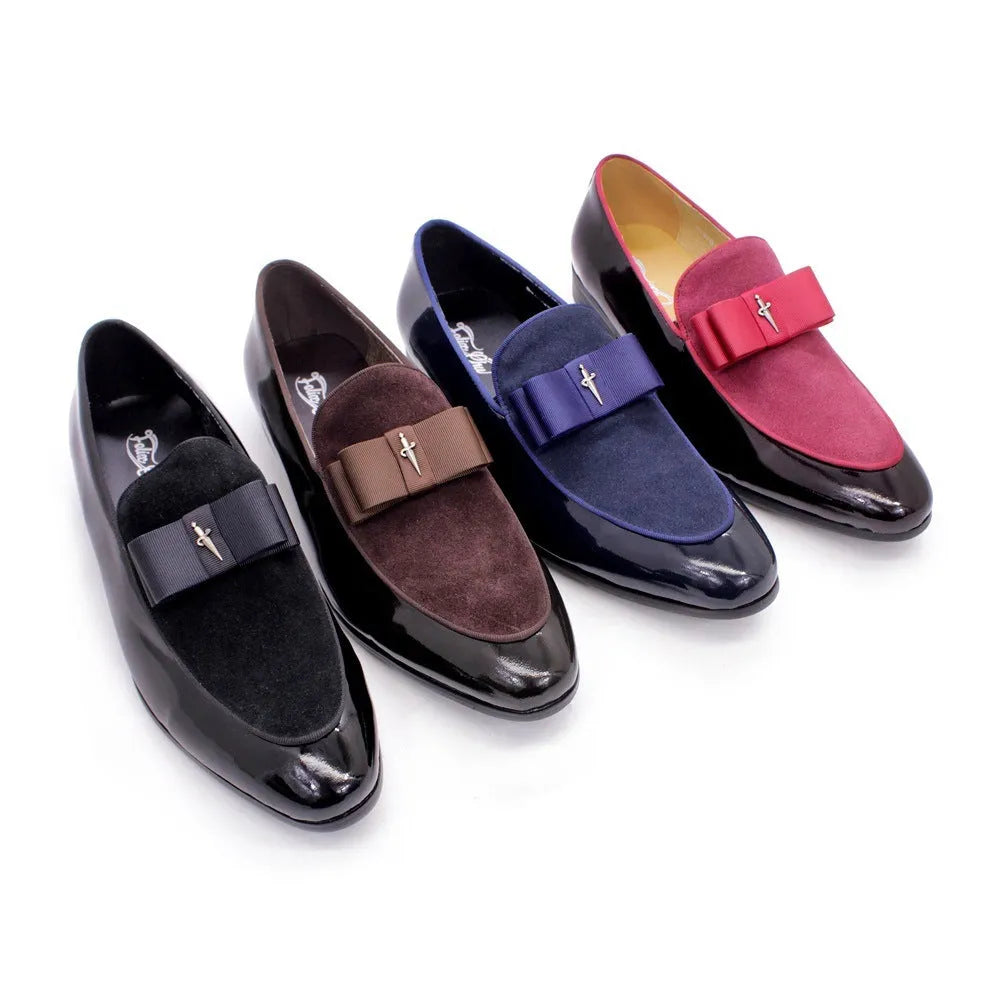 Men's black patent leather dress shoes with a gold tassel detail on the front.