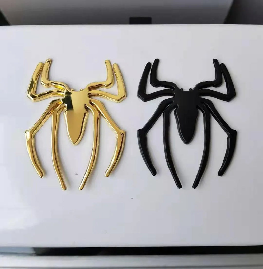 3D metal spider car bumper sticker in gold, silver, black, or red on a white background