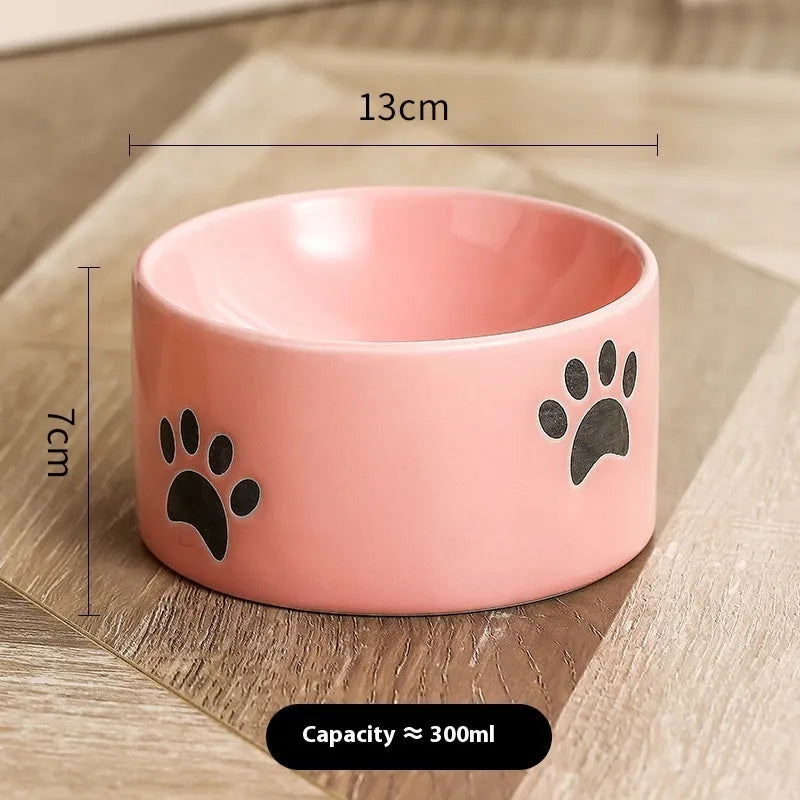 Ceramic cat bowl with oblique mouth and high foot, available in cat's paw colours pink, yellow, black, white