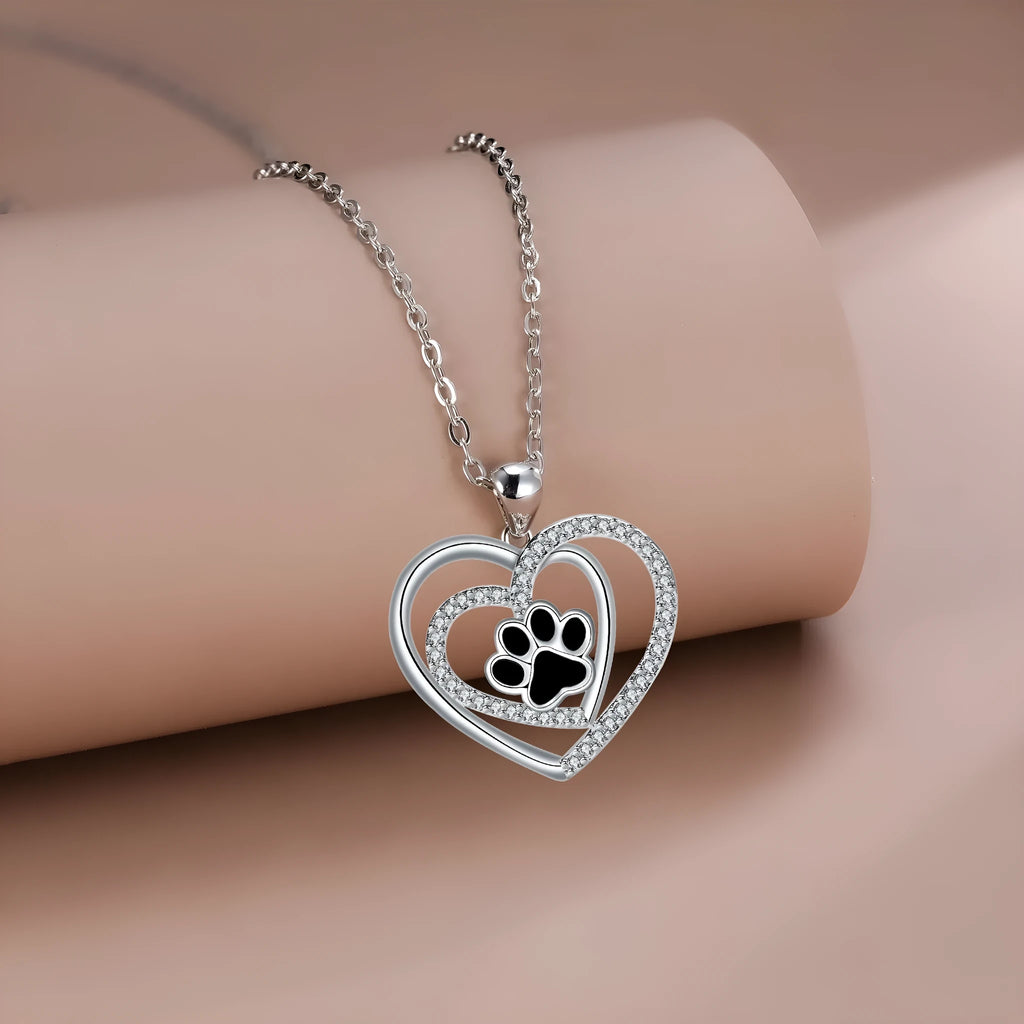 Original design women's necklace with copper dog paw print pendant on a cross chain.